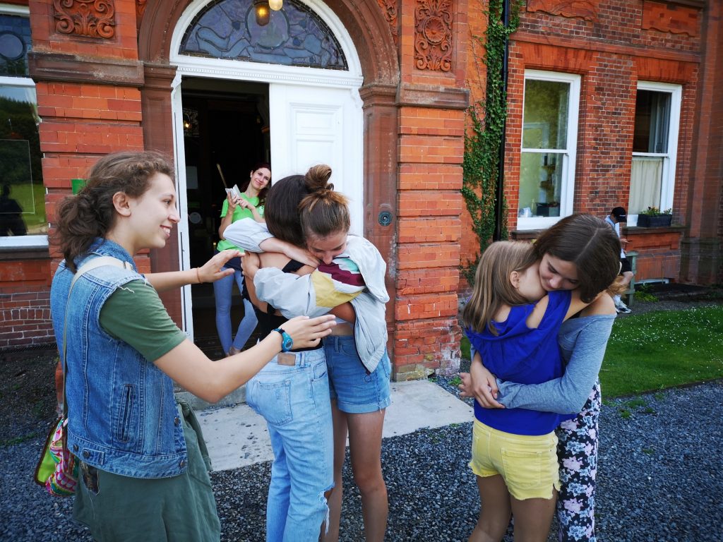 Friends saying goodbye before departing from More Than English summer school.